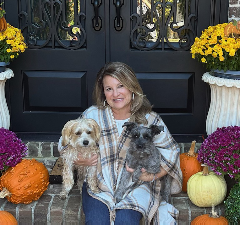 Our owner, Robin, holding her two little dogs